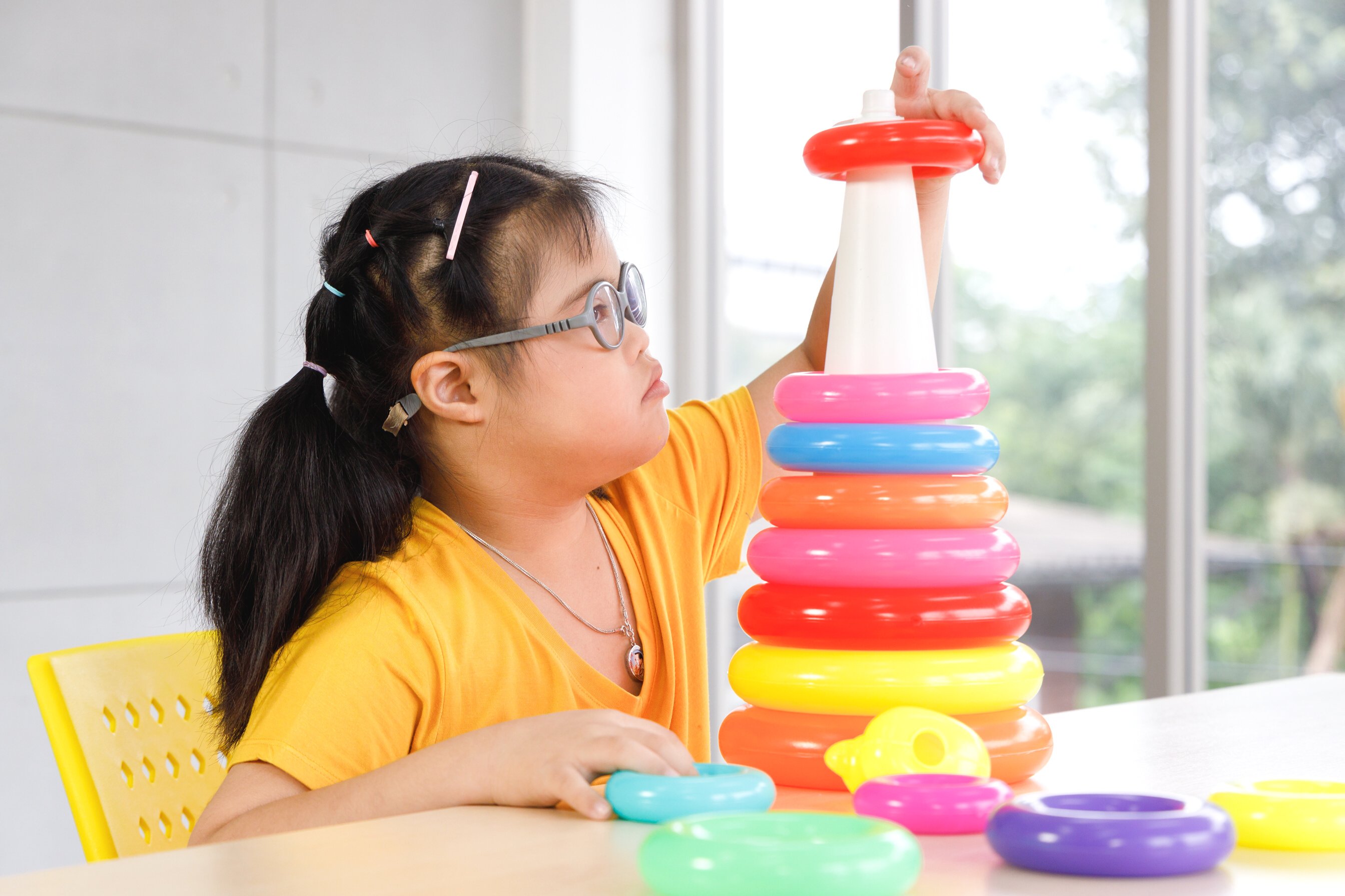 Girl with Down's syndrome play toy.