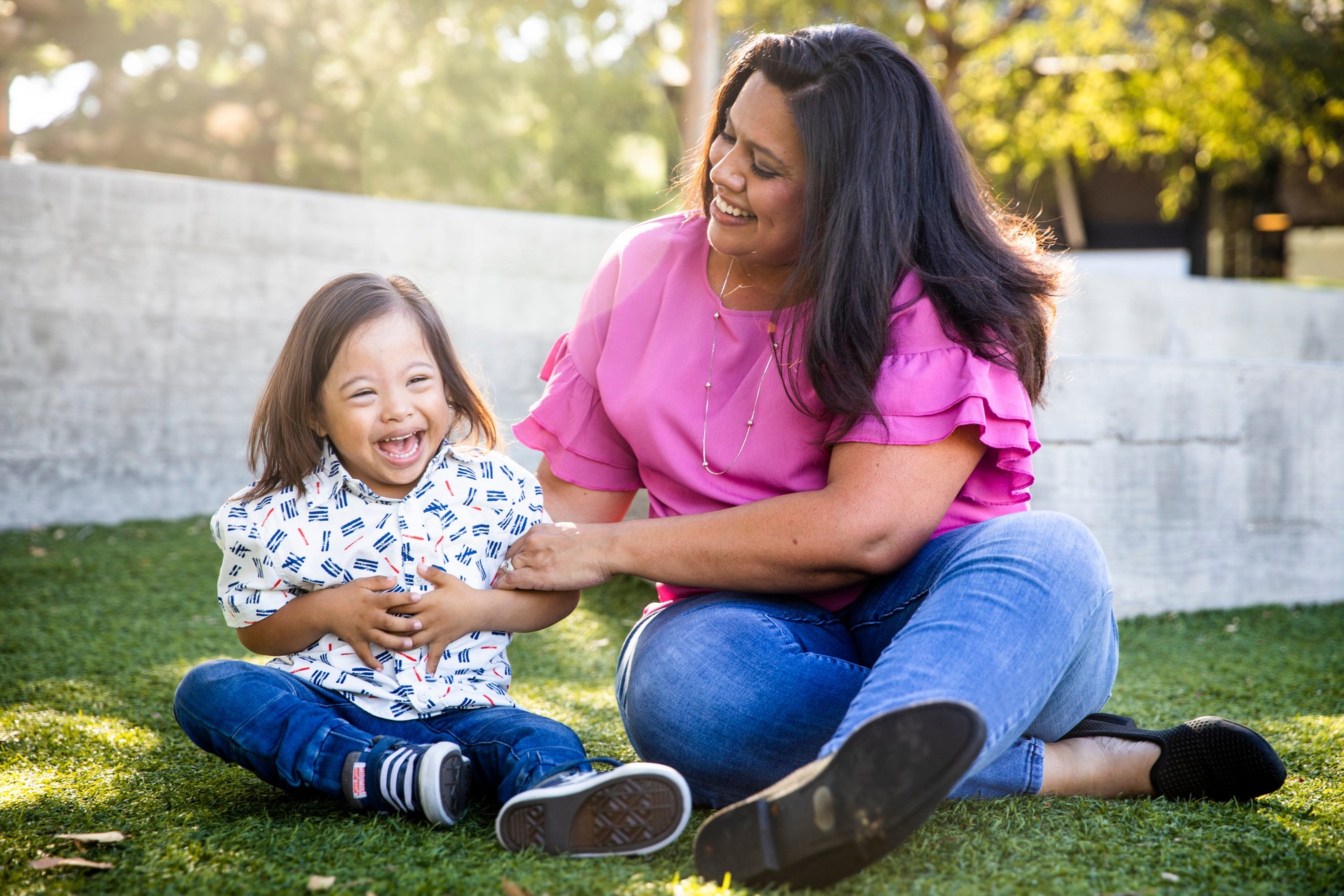 Young Mexican Mom Playing with Down's Syndrome Son in Park